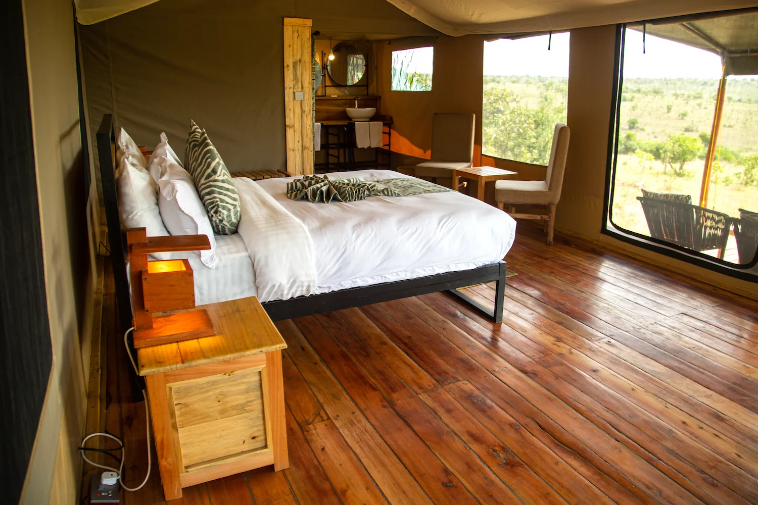 Guest bedroom overlooking the landscape at Baobab Mara Luxury Camp