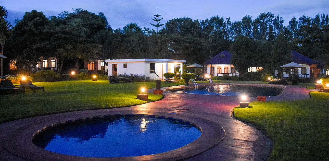 Pool and gardens at Bougainvillea Safari Lodge at dusk