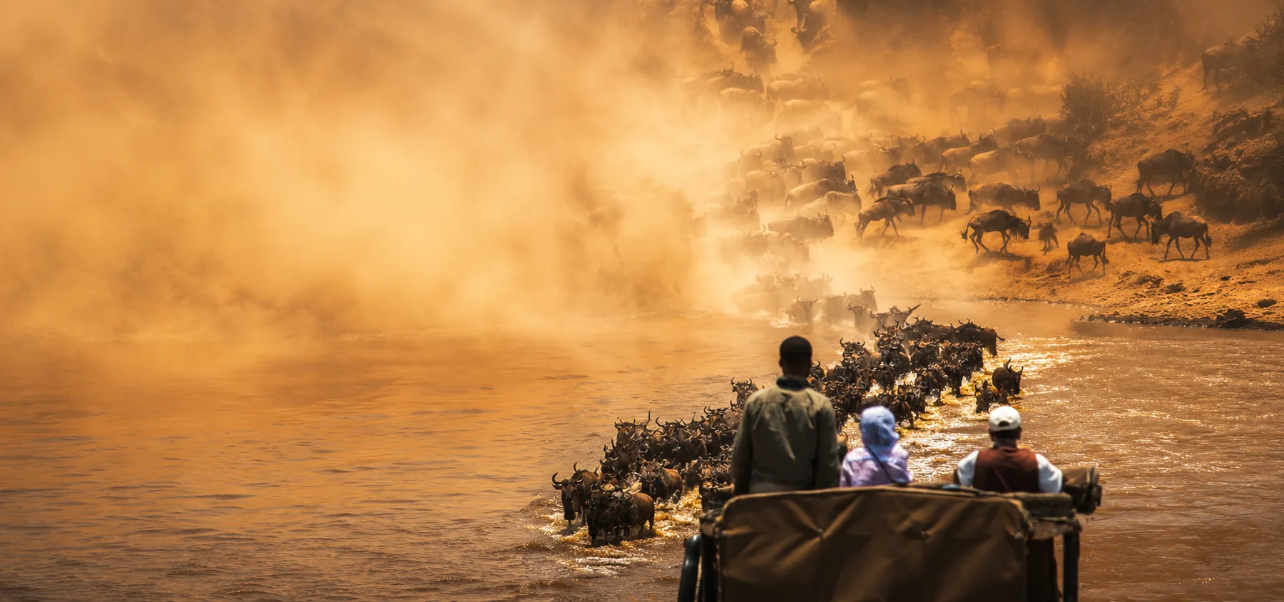 Wildebeest herd and safari vehicle in the Kogatende area of northern Serengeti